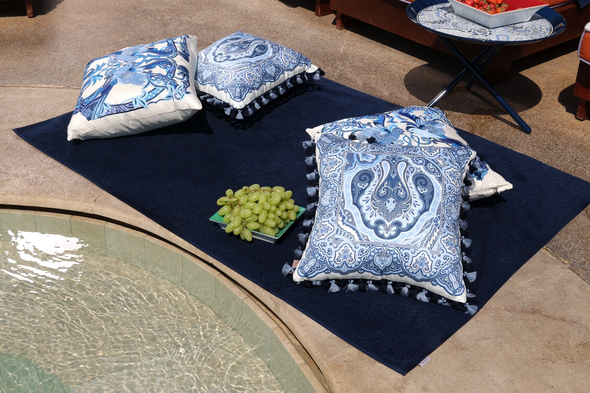 Bloom decorative tray, SYRAH goblet and SHANTI throw on a poolside table